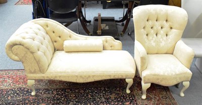 Lot 1377 - A bedroom chaise longue in buttoned and floral fabric; together with a matching armchair (2)