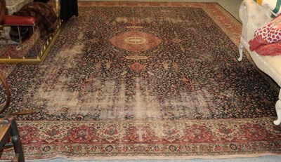 Lot 1388 - A large machine made carpet of classical Persian design, the deep indigo field with central...