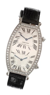 Lot 642 - A Fine 18ct White Gold Diamond Set Two Time Zone Curved Tonneau Shaped Wristwatch, signed...