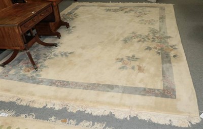 Lot 1394 - A large Chinese cream ground carpet, 360cm by 270cm