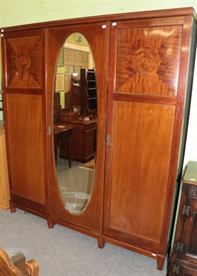 Lot 1407 - An Edwardian mahogany triple wardrobe