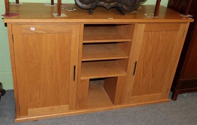 Lot 1408 - An oak TV cabinet (modern)