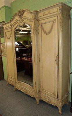 Lot 1411 - A 19th century French cream painted triple door wardrobe, 230cm by 47cm by 243cm high