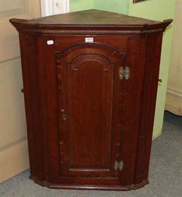 Lot 1413 - A George III mahogany hanging corner cupboard