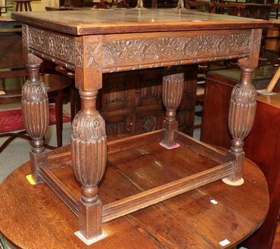 Lot 1435 - A carved oak side table