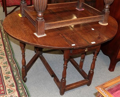 Lot 1436 - An early 18th century gate leg dining table with spindle legs