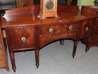 Lot 1447 - Early 19th century mahogany bow fronted sideboard on turned and reeded legs, 183cm wide