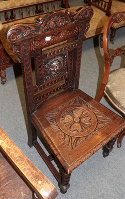 Lot 1453 - A carved oak chair