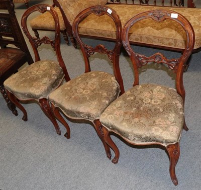 Lot 1454 - A set of three Victorian walnut balloon back dining chairs