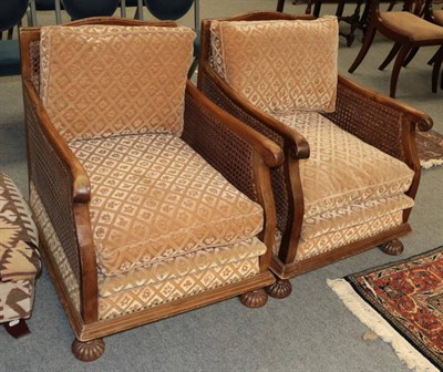 Lot 1457 - A pair of 1920's walnut bergere armchairs