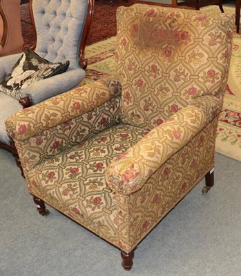 Lot 1464 - A Victorian armchair, late 19th century covered in green and floral geometric patterned fabric, the