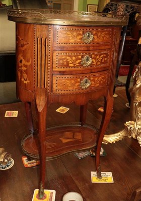 Lot 1471 - A French marquetry inlaid oval bedside chest of drawers