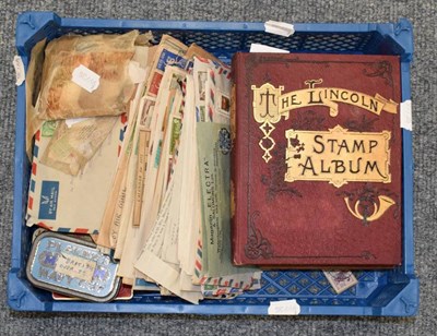 Lot 116 - Blue Plastic Tray with an old accumulation in packets, tins, covers and a Lincoln stamp album. Note
