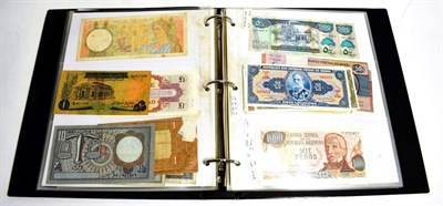 Lot 206 - An album of World banknotes including notes from Canada, Hong Kong, Angola, New Zealand, Cuba,...