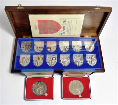 Lot 232 - The Royal Arms, a set of 12 silver shield shaped ingots depicting the different Royal Arms as...