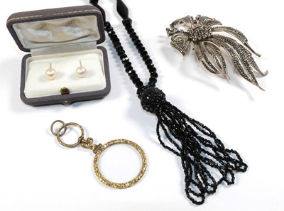 Lot 60 - A silver marcasite set brooch in the form of a floral spray; a gilt metal magnifying glass; a black