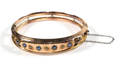 Lot 72 - A sapphire and diamond bangle, stamped '9' '.375', cased