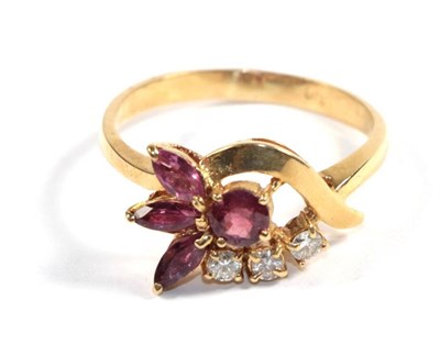 Lot 82 - A ruby and diamond cluster ring, stamped 'K18', finger size Q1/2