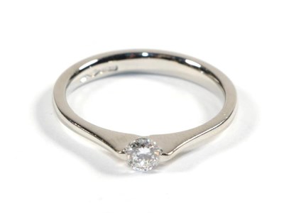 Lot 98 - A platinum solitaire diamond ring, a round brilliant cut diamond in a tension setting, to knife...