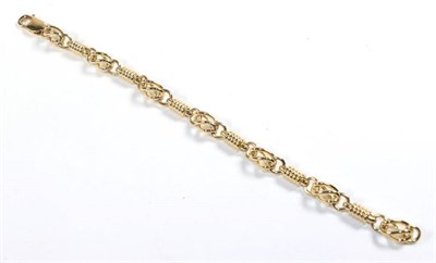 Lot 101 - A fancy link bracelet, stamped '375', length 19cm