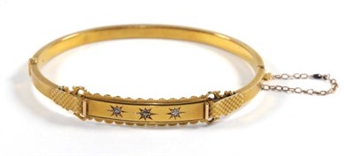 Lot 111 - A diamond set bangle stamped '15CT', inner diameter 5.7cm by 4.5cm, cased