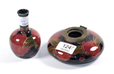 Lot 124 - A small Moorcroft pottery bottle vase; and an inkwell, both pomegranate pattern (2)