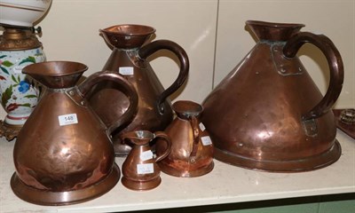 Lot 148 - A set of five copper graduated jugs