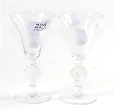 Lot 224 - A pair of Lalique wine glasses with mask stem decoration