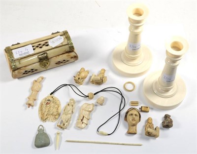 Lot 234 - A pair of ivory candlesticks, first quarter 20th century; a bone casket; and a box of small ivory