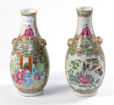 Lot 246 - A pair of early 20th century Canton famille rose twin handled bottle vases