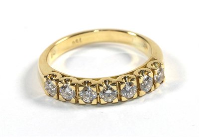 Lot 251 - A seven stone diamond ring, stamped '750', finger size Q1/2