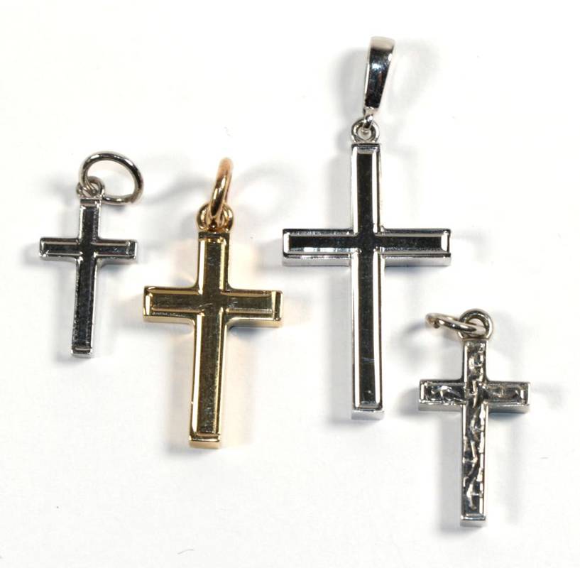 Lot 274 - Three 9 carat white gold cross pendants; and a 9 carat gold cross pendant, of varying sizes (4)