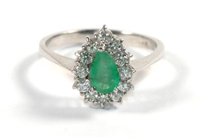 Lot 279 - An emerald and diamond cluster ring, stamped '18K', finger size S