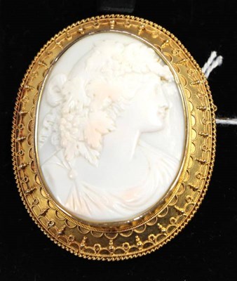 Lot 343 - A cameo brooch, depicting Bacchus, within an oval bead and decorated rope work frame, circa...