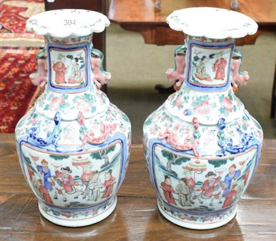 Lot 394 - A pair of late 19th century Chinese porcelain vases decorated with figures in various landscapes