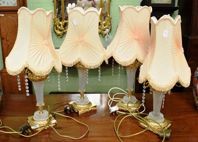 Lot 399 - A set of four modern cut glass gilt metal mounted table lamps