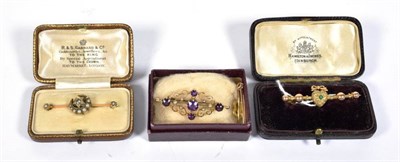 Lot 407 - An amethyst and seed pearl bar brooch, stamped '15CT', length 4.1cm; together with three other...