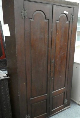 Lot 1146 - A Georgian oak corner cupboard