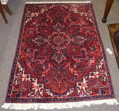 Lot 1159 - Heriz rug, the crimson field with cruciform medallion framed by spandrels and narrow borders, 154cm