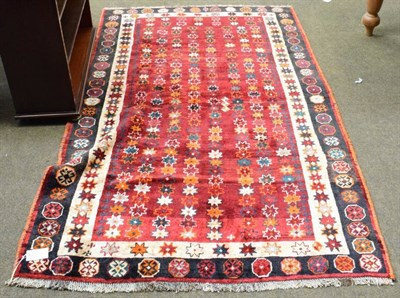 Lot 1162 - Kashgai rug, the abrashed raspberry field of stellar motifs enclosed by ivory borders, 203cm by...