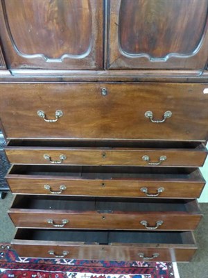 Lot 1167 - A George III mahogany secretaire chest, the upper section with moulded panel doors above a...