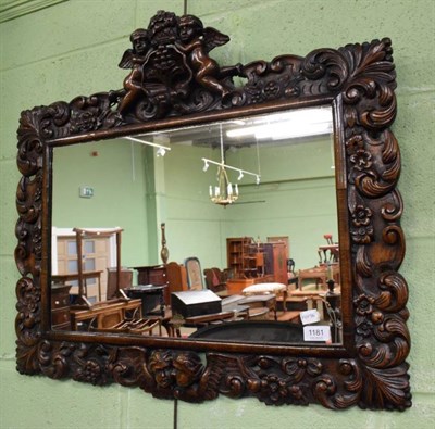Lot 1181 - A carved oak Baroque style wall mirror