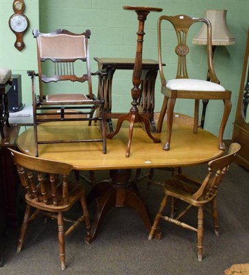 Lot 1193 - A light oak dining table; four spindle back kitchen chairs; two further chairs; a torchere; and...