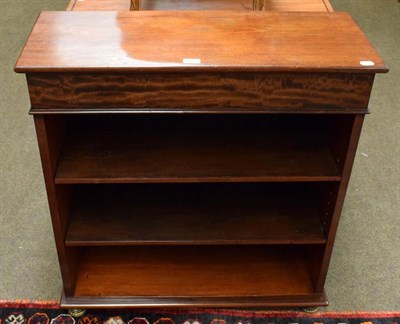 Lot 1198 - A mahogany freestanding bookcase, two adjustable shelves, brass mounted feet
