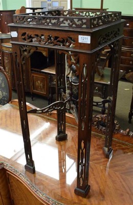 Lot 1211 - A mahogany fret-cut stand, galleried top, candle slide, canted legs with finialed cross stretchers