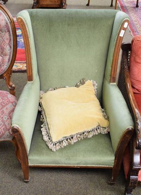 Lot 1231 - A late Victorian green upholstered armchair
