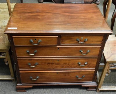 Lot 1238 - A Georgian style mahogany chest of drawers, two short over three long graduated, quarter column...