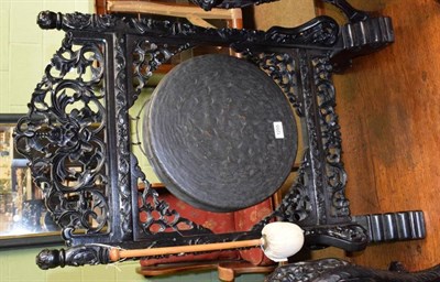 Lot 1255 - An ebonised 19th century gong with beater