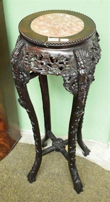 Lot 1256 - A carved Chinese jardiniere stand with marble top