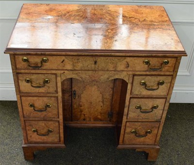 Lot 1271 - An 18th century style burr walnut veneered kneehole desk